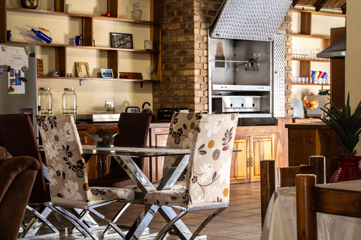 Covered braai and entertainment area with brickwork and thatch architecture