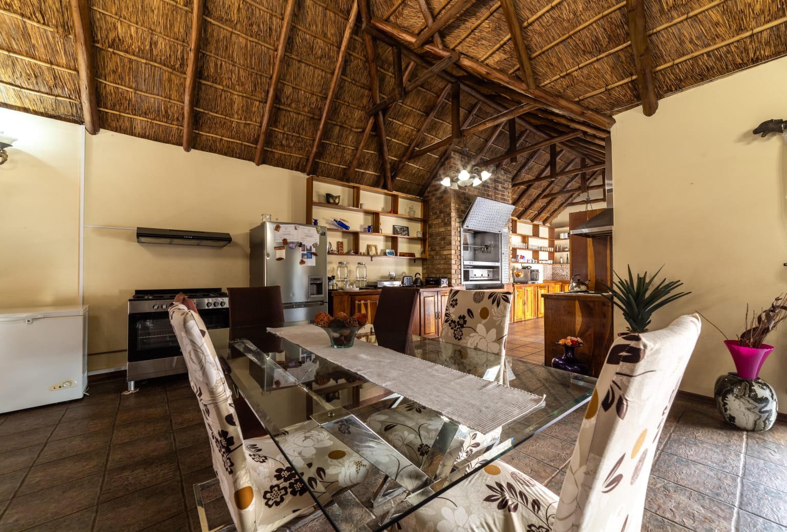 Rustic guesthouse decor in the thatch-roofed dining room at Thatch Haven