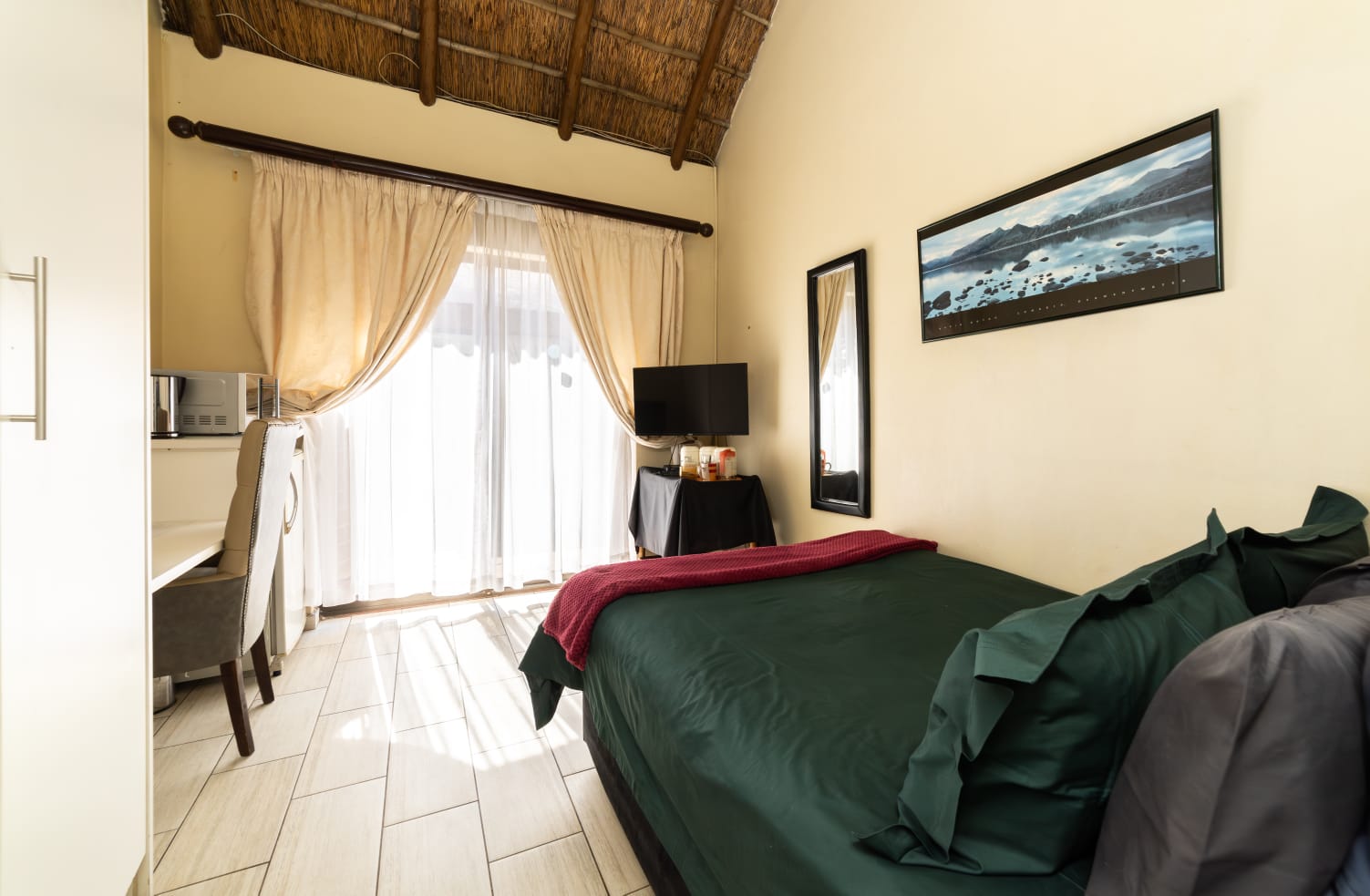 Pool Room 2 at Thatch Haven Guesthouse Centurion with double bed and thatch roof