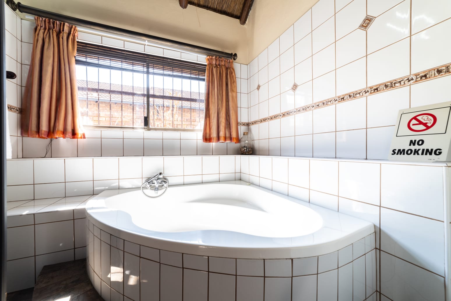 VIP Room 1 en-suite bathroom with view into the bright bedroom