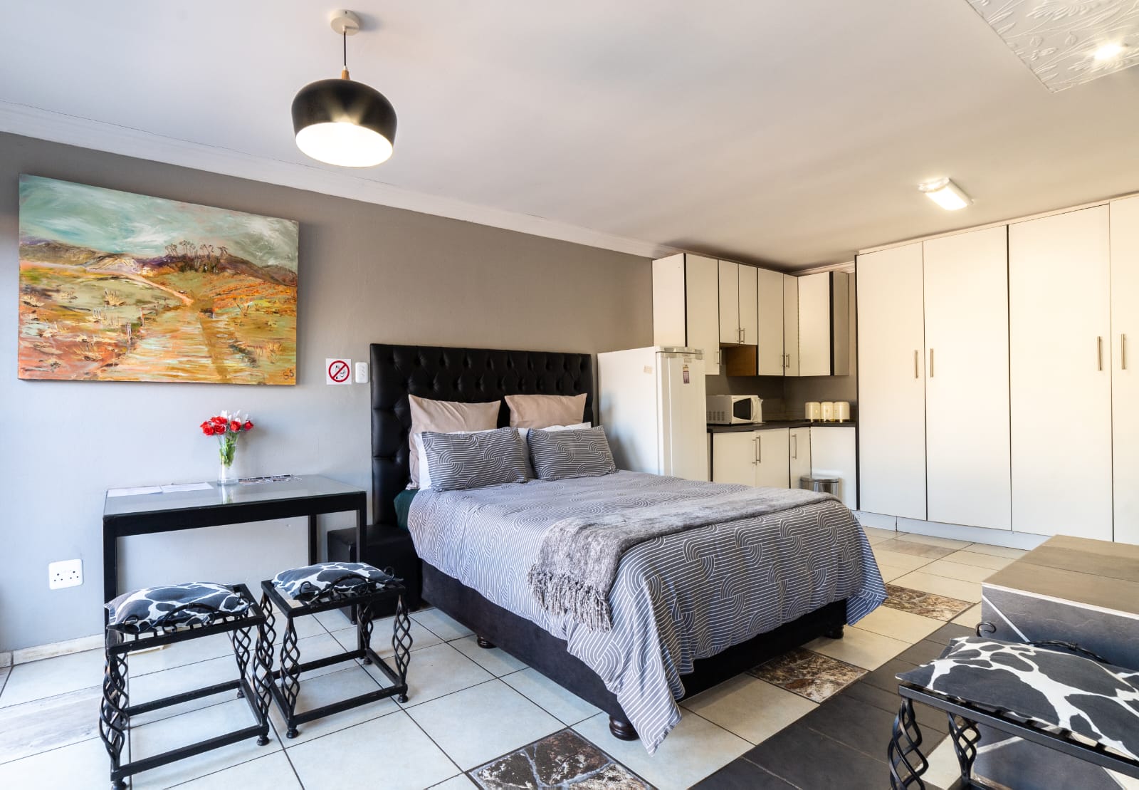 VIP Room 2 at Thatch Haven Guesthouse Centurion with thatch roof and king-sized bed