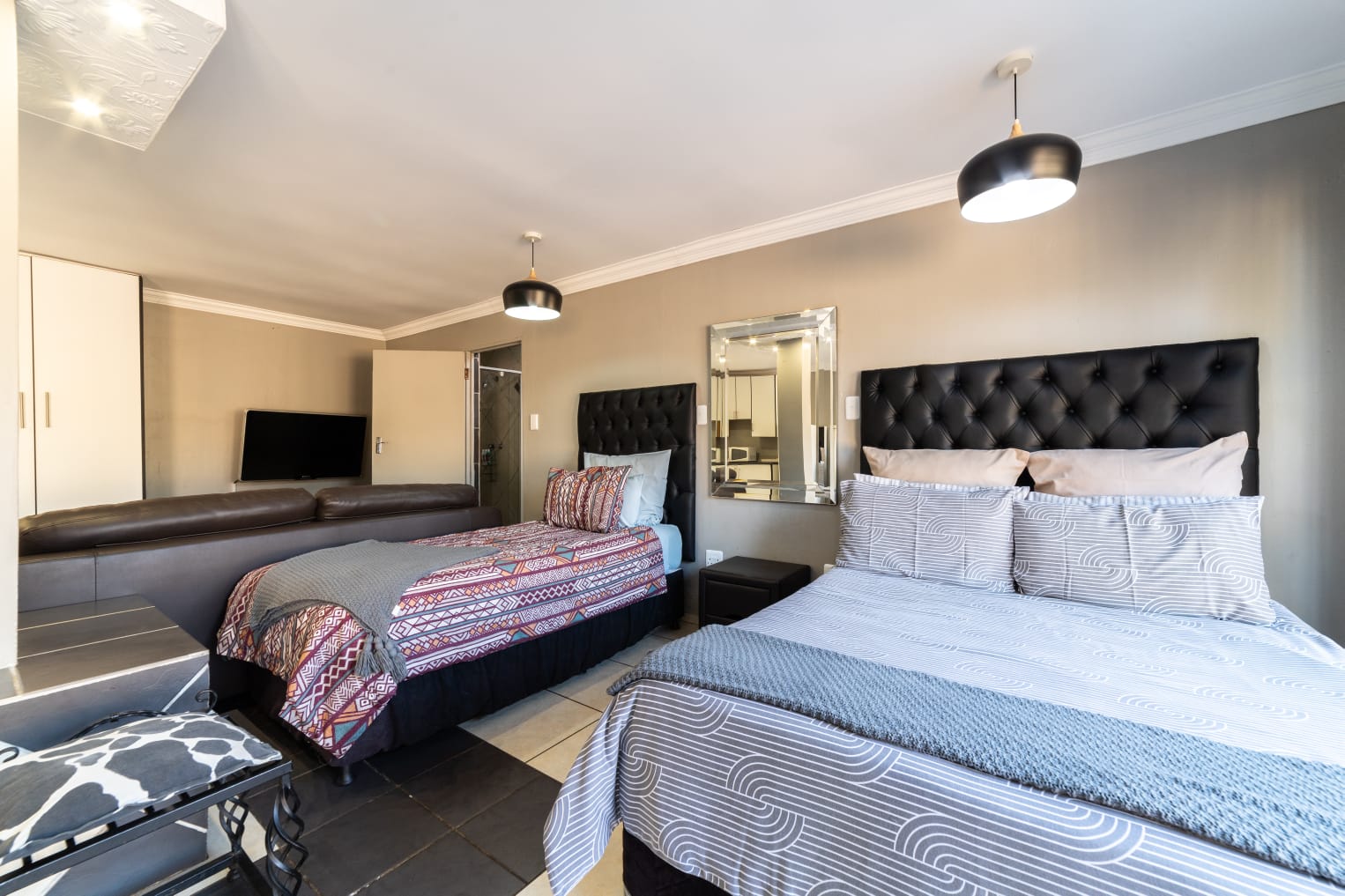 VIP Room 2 with African-inspired decor and rustic headboard