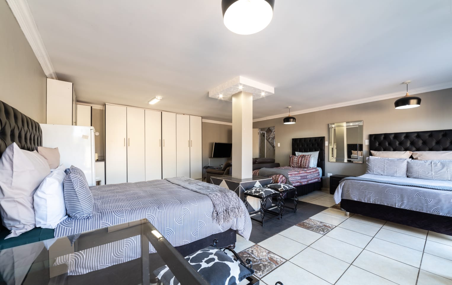 VIP Room 2 amenities - wall-mounted TV, bar fridge, microwave and desk
